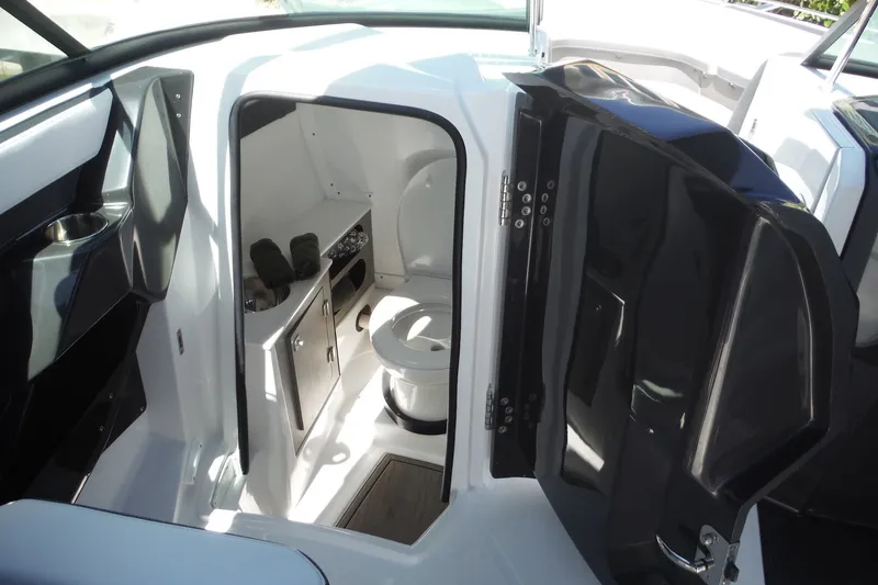 Slide: The Image of 2024 Monterey 255SS Super Sport boat interior with compact bathroom and storage. - 32