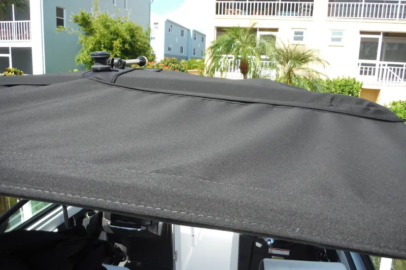 Slide: The Image of 2024 Monterey 255SS Super Sport boat with black canvas top, outdoor setting. - 37