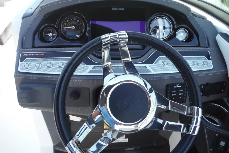 Slide: The Image of 2024 Monterey 255SS Super Sport dashboard with chrome steering wheel and modern gauges. - 13