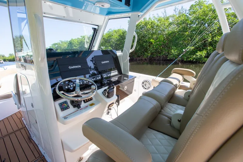 Slide: The Image of 2020 Everglades 365 Center Console boat interior with Garmin navigation system and luxurious seating. - 20