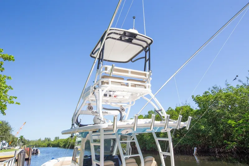 Slide: The Image of 2020 Everglades 365 Center Console boat with tower, docked on a sunny day. - 18