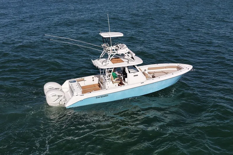 Slide: The Image of 2020 Everglades 365 Center Console boat cruising on open water. - 26