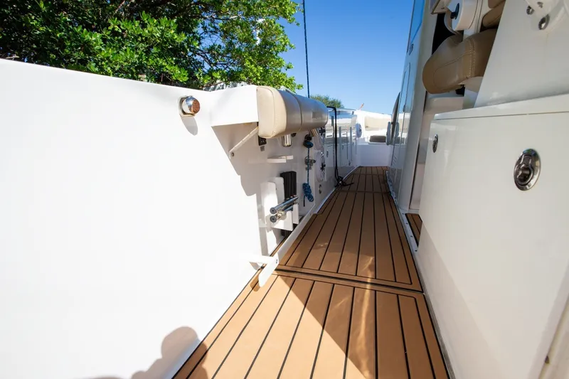 Slide: The Image of 2020 Everglades 365 Center Console boat deck with teak flooring and white cabinetry. - 19
