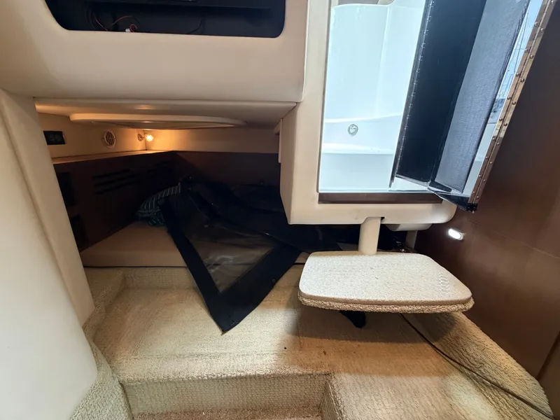 Slide: The Image of Interior of a 2014 Sea Ray Sundancer 280 with carpeted flooring and seating area. - 36