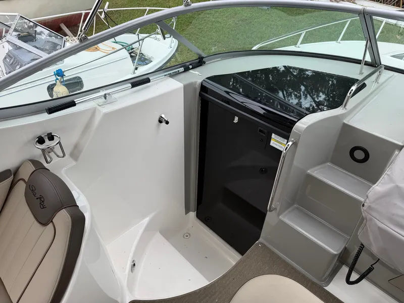 Slide: The Image of The image shows the cockpit of a 2014 Sea Ray Sundancer 280 with beige seating and helm console. - 20