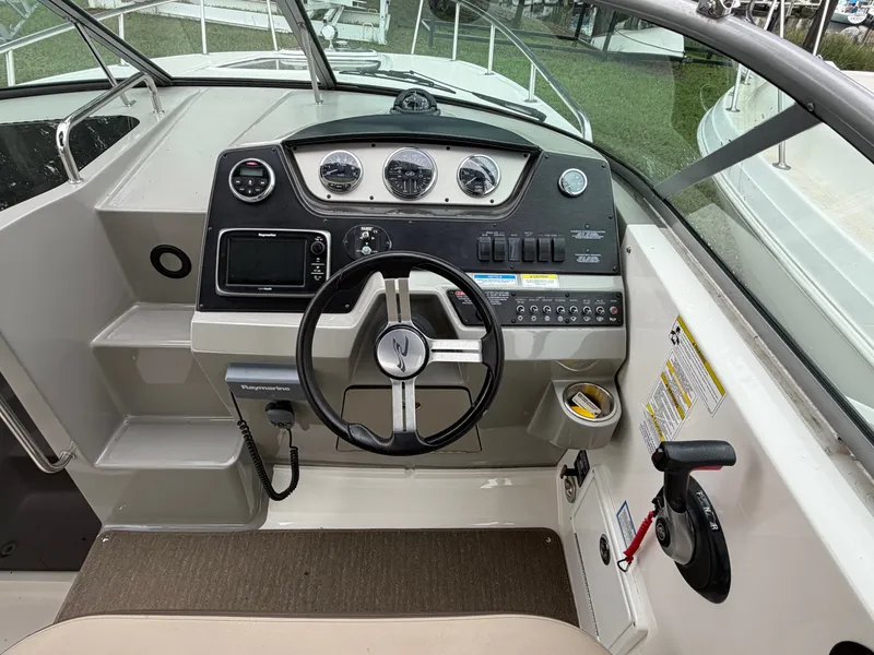Slide: The Image of The cockpit of a 2014 Sea Ray Sundancer 280 with a modern helm and instruments. - 22