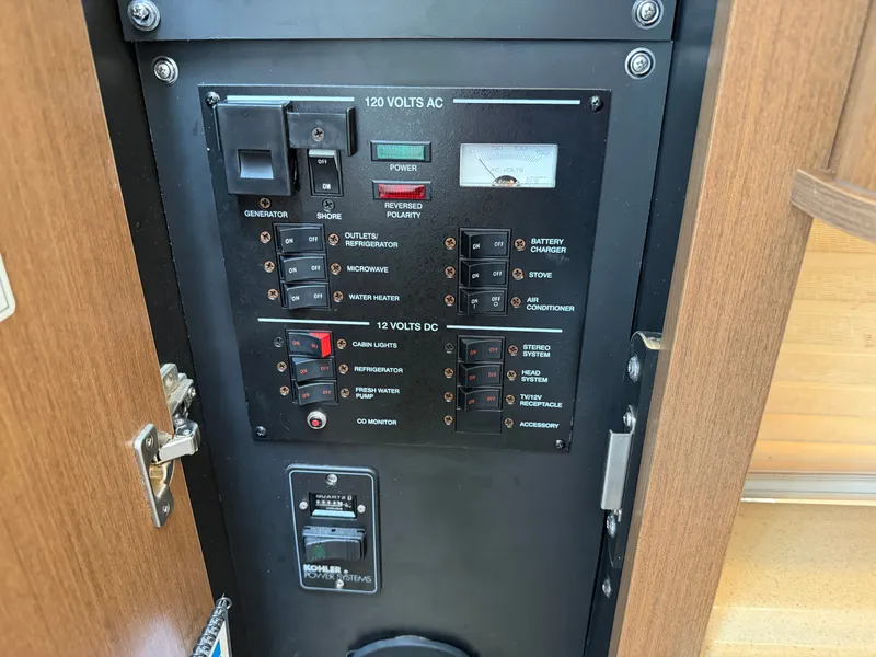 Slide: The Image of An electrical panel with switches and indicators for various boat functions. - 39