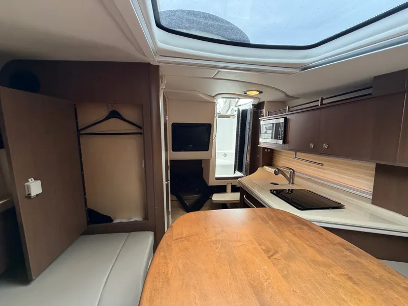 Slide: The Image of Interior of the 2014 Sea Ray Sundancer 280 with kitchen and dining area. - 35