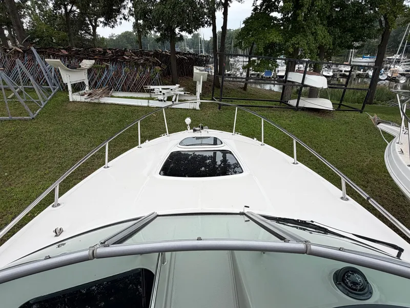Slide: The Image of The image shows the bow of a 2014 Sea Ray Sundancer 280, positioned on grass. - 24