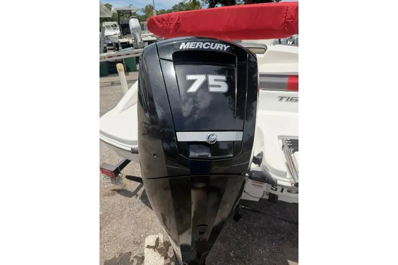 Slide: The Image of Mercury 75 outboard motor on 2021 Tahoe T16 boat, parked outdoors. - 8