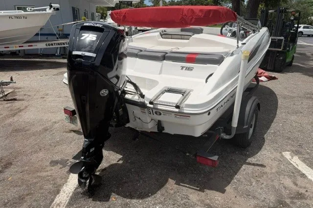 Slide: The Image of 2021 Tahoe T16 boat with Mercury 75 engine, parked on a trailer. - 6