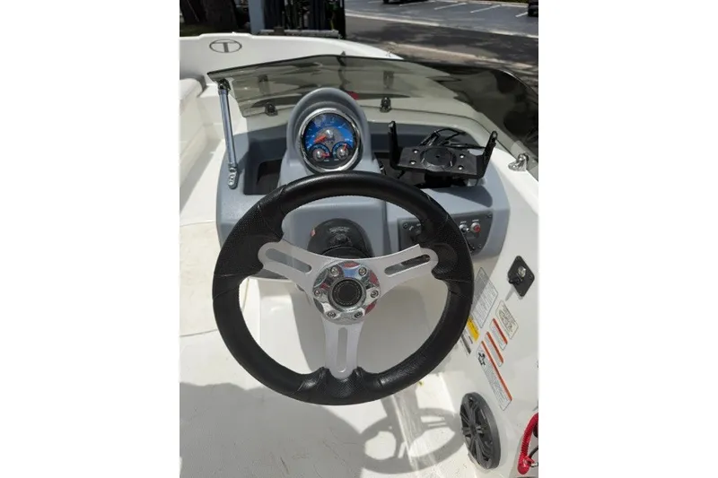 Slide: The Image of 2021 Tahoe T16 boat dashboard with steering wheel and instrument panel. - 11
