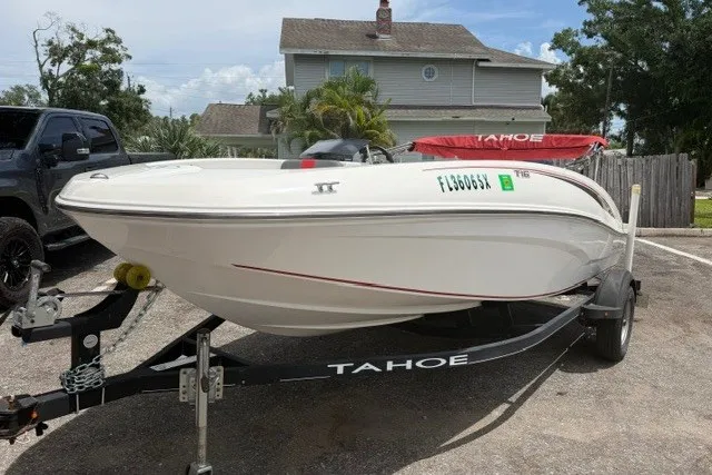 Slide: The Image of 2021 Tahoe T16 boat on trailer in residential driveway, sunny day. - 3