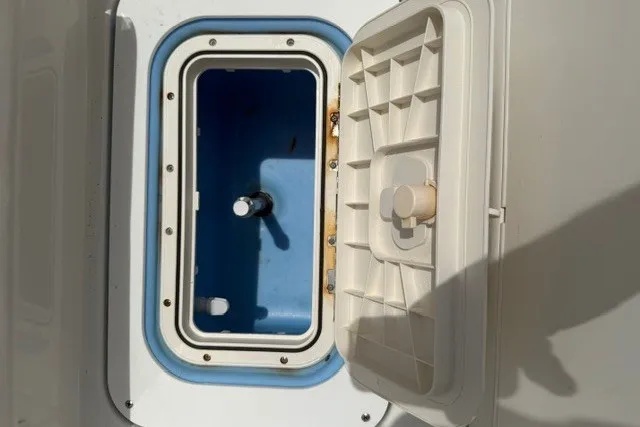 Slide: The Image of Open storage compartment on a 2021 Tahoe T16 boat, featuring a blue interior. - 14