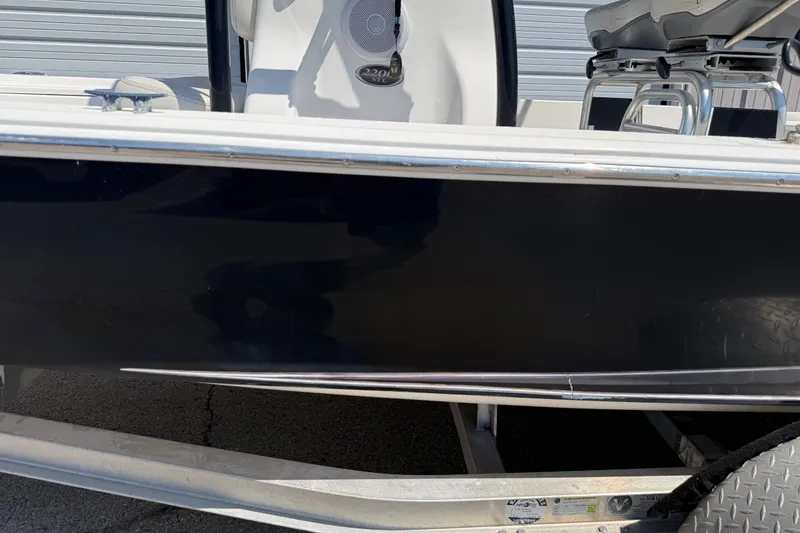 Slide: The Image of 2016 Blue Wave 2200 STL boat side view on trailer. - 11
