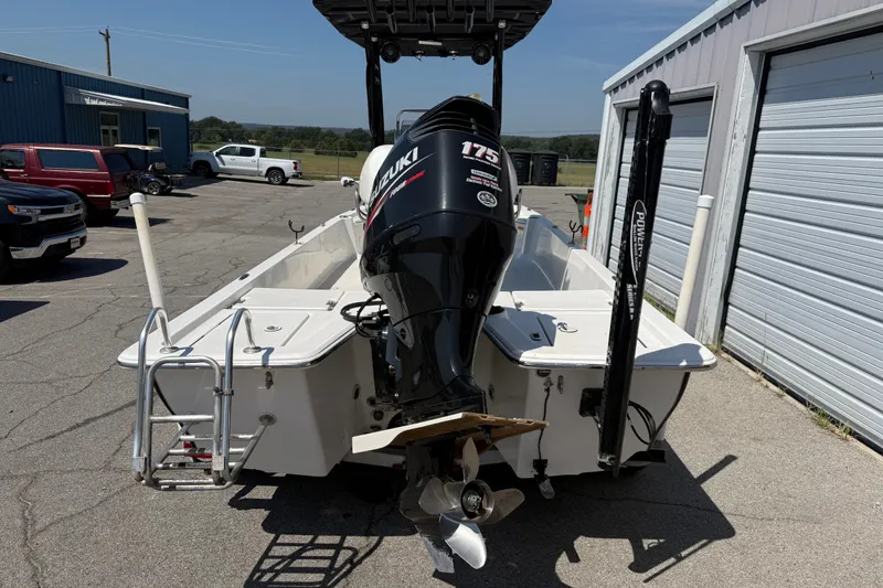 Slide: The Image of 2016 Blue Wave 2200 STL boat with Suzuki 175 outboard motor, parked near garages. - 4