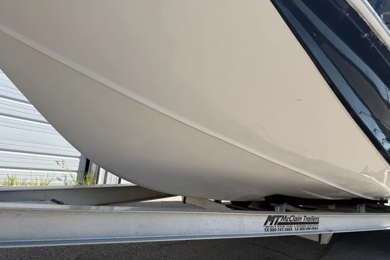 Slide: The Image of 2016 Blue Wave 2200 STL boat on McClain trailer, side view. - 12