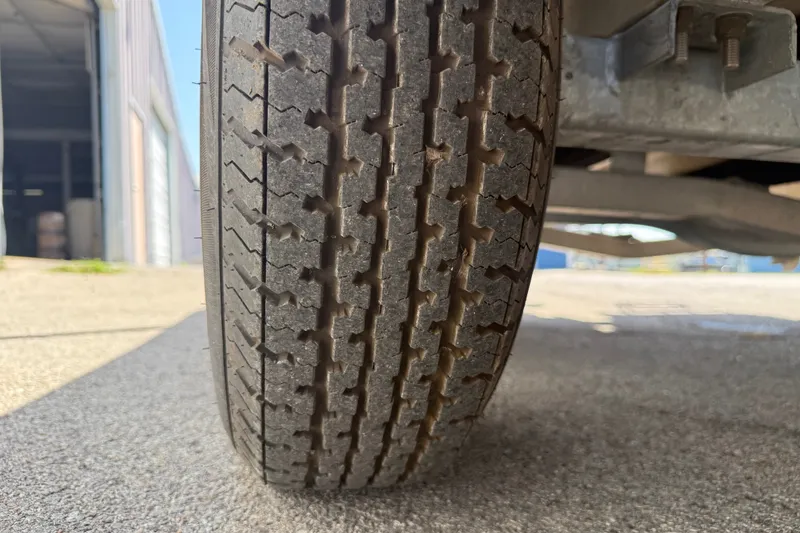 Slide: The Image of Close-up of a 2016 Blue Wave 2200 STL trailer tire on concrete surface. - 41