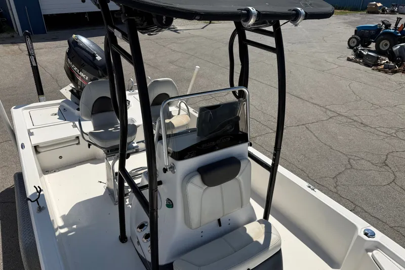 Slide: The Image of 2016 Blue Wave 2200 STL boat with seating and console, parked on pavement. - 18