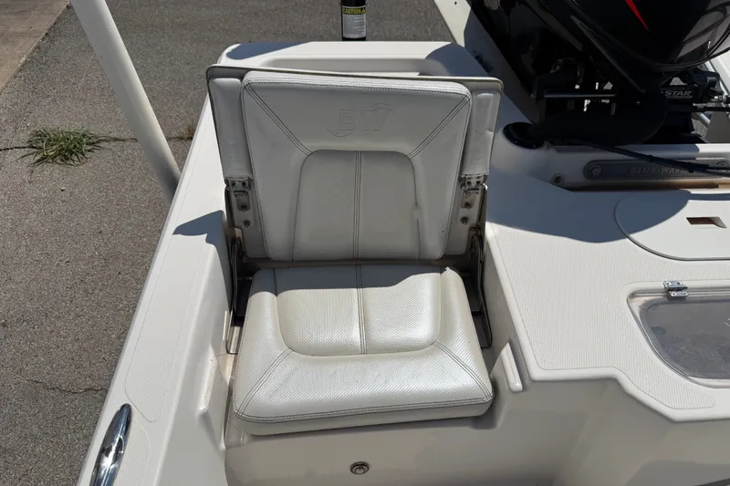 Slide: The Image of 2016 Blue Wave 2200 STL boat seat, white upholstery, outdoor setting. - 29