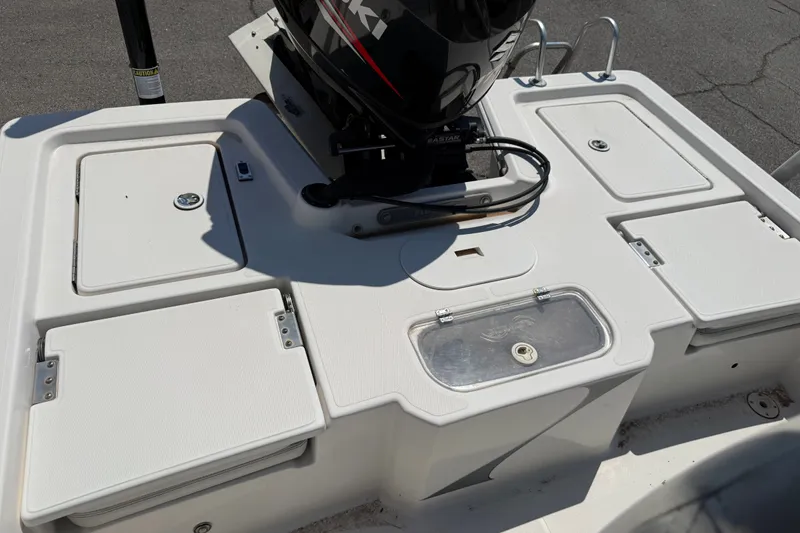 Slide: The Image of 2016 Blue Wave 2200 STL boat deck with storage compartments and motor. - 28