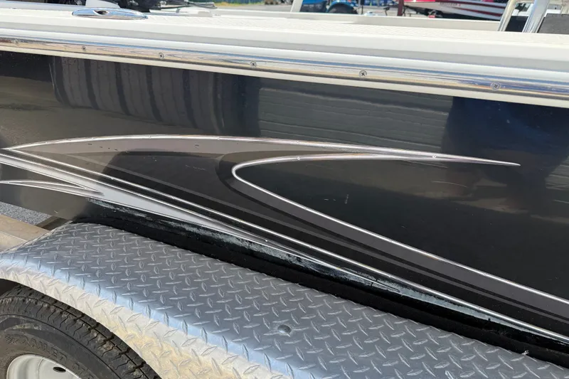 Slide: The Image of 2016 Blue Wave 2200 STL boat side view with sleek design on a trailer. - 8