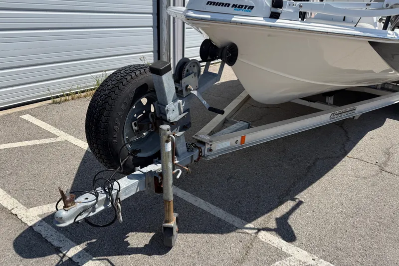 Slide: The Image of 2016 Blue Wave 2200 STL boat on trailer, featuring Minn Kota trolling motor. - 2