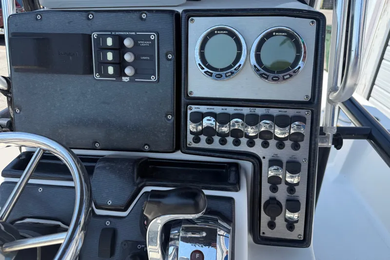 Slide: The Image of Control panel of a 2016 Blue Wave 2200 STL boat with gauges and switches. - 23