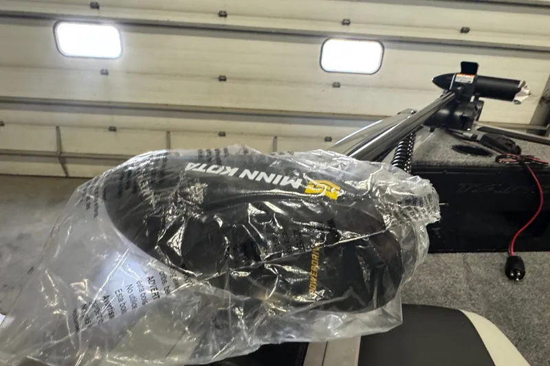 Slide: The Image of 2027 Tracker Targa V-18 Combo boat with Minn Kota motor in garage. - 14