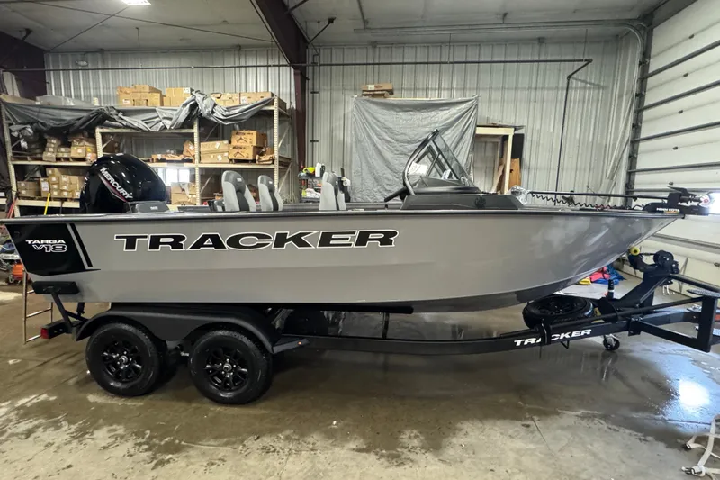 The Image of 2027 Tracker Targa V-18 Combo boat in a garage, on a trailer, side view. - 0