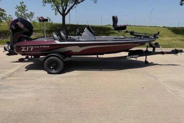 Slide: The Image of 2027 Nitro Z17 boat on trailer, parked outdoors, side view. - 23