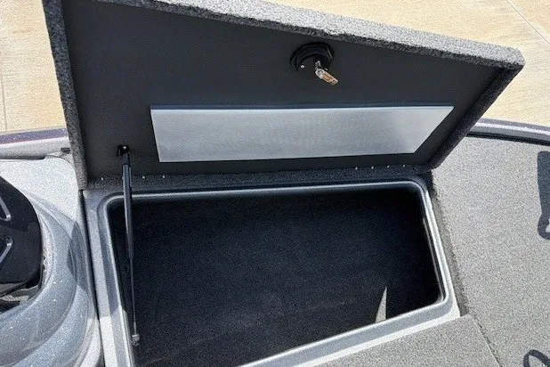 Slide: The Image of Open storage compartment in a 2027 Nitro Z17 boat, featuring a secure lock mechanism. - 26
