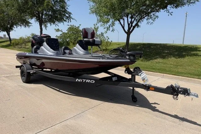 Slide: The Image of Nitro Z17 2027 model boat on trailer, parked on sunny street. - 21