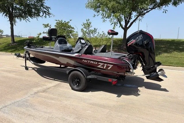 Slide: The Image of 2027 Nitro Z17 boat on trailer, parked outdoors, featuring sleek design and powerful engine. - 19