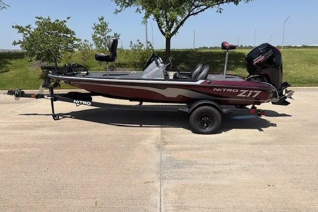 The Image of 2027 Nitro Z17 boat on trailer, parked outdoors on sunny day. - 18