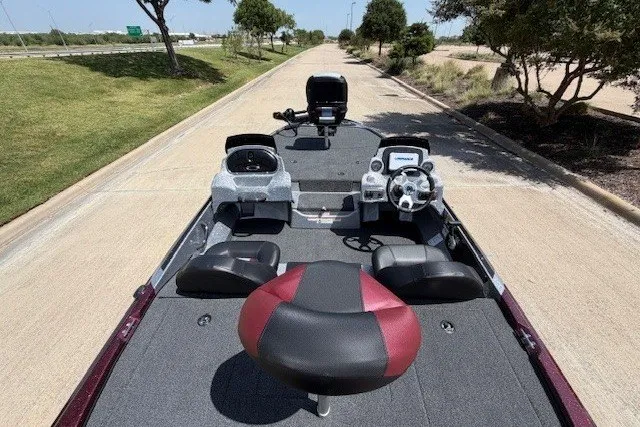 Slide: The Image of 2027 Nitro Z17 boat interior with steering wheel and seating on a paved road. - 34