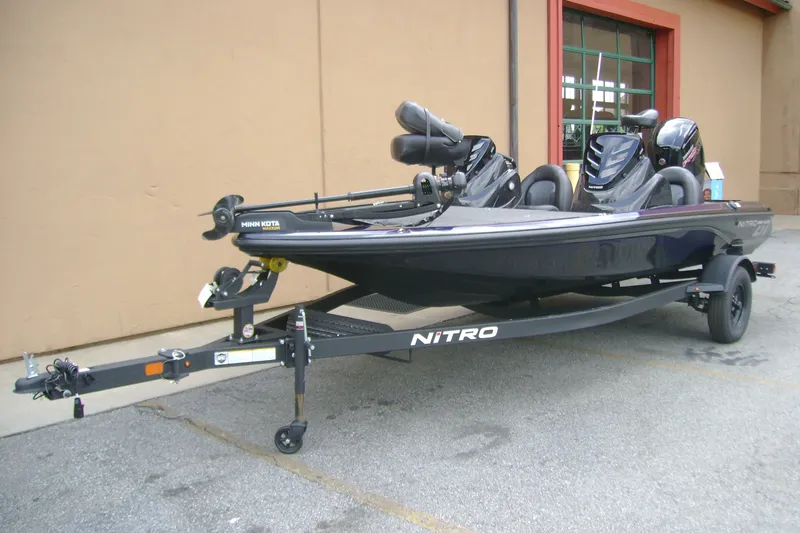 Slide: The Image of 2027 Nitro Z17 boat on trailer, parked outdoors, featuring Minn Kota trolling motor. - 3