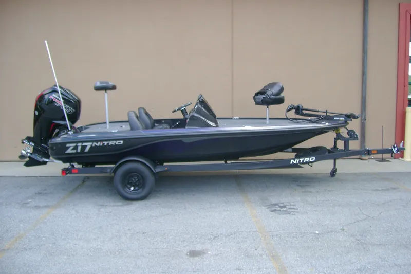 The Image of 2027 Nitro Z17 fishing boat on trailer, side view, parked outdoors. - 0
