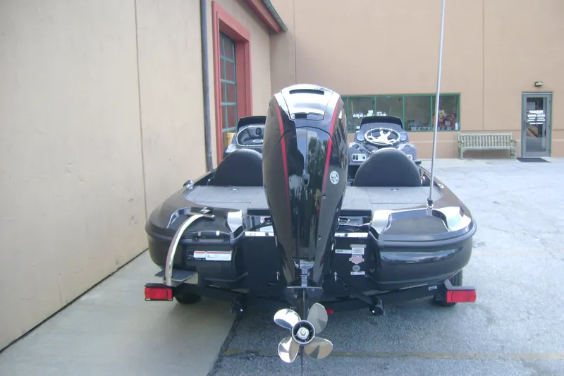 Slide: The Image of 2027 Nitro Z17 boat with powerful outboard motor, parked near a building. - 7