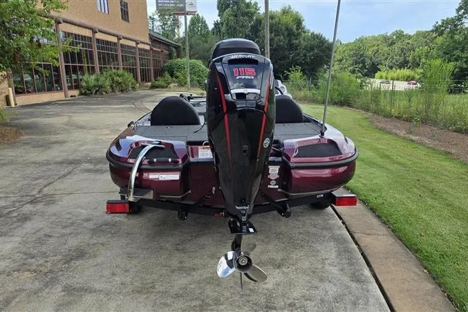 Slide: The Image of 2027 Nitro Z17 boat with Mercury 115 outboard motor, parked outdoors. - 2