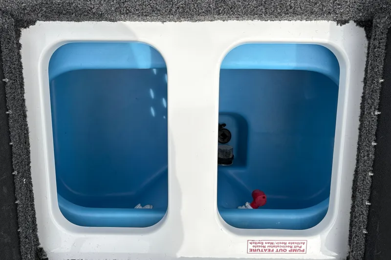 Slide: The Image of Dual blue compartments in a 2027 Nitro Z17 boat, featuring pump-out system. - 25