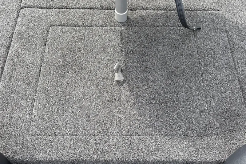 Slide: The Image of Carpeted deck of a 2027 Nitro Z17 boat with a metal pole and latch. - 41