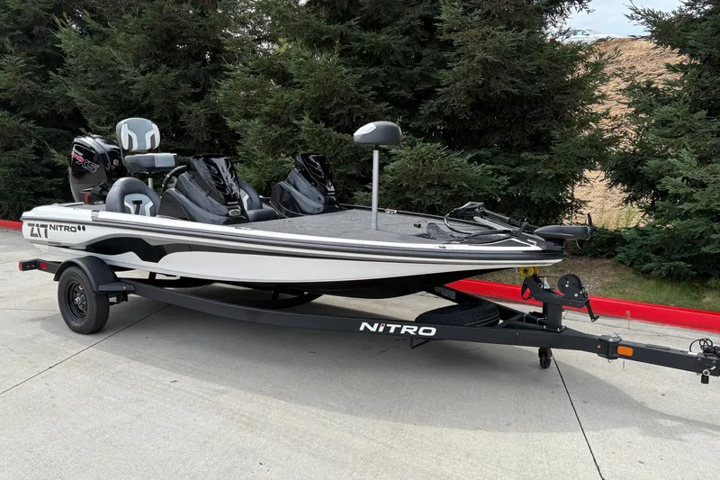 Slide: The Image of 2027 Nitro Z17 boat on trailer, parked outdoors near trees. - 5