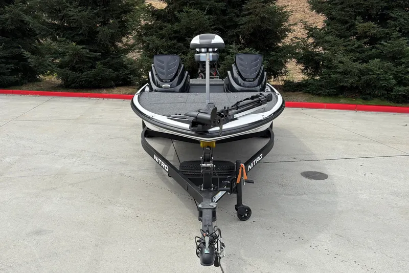Slide: The Image of 2027 Nitro Z17 boat on trailer, parked on concrete with trees in background. - 6