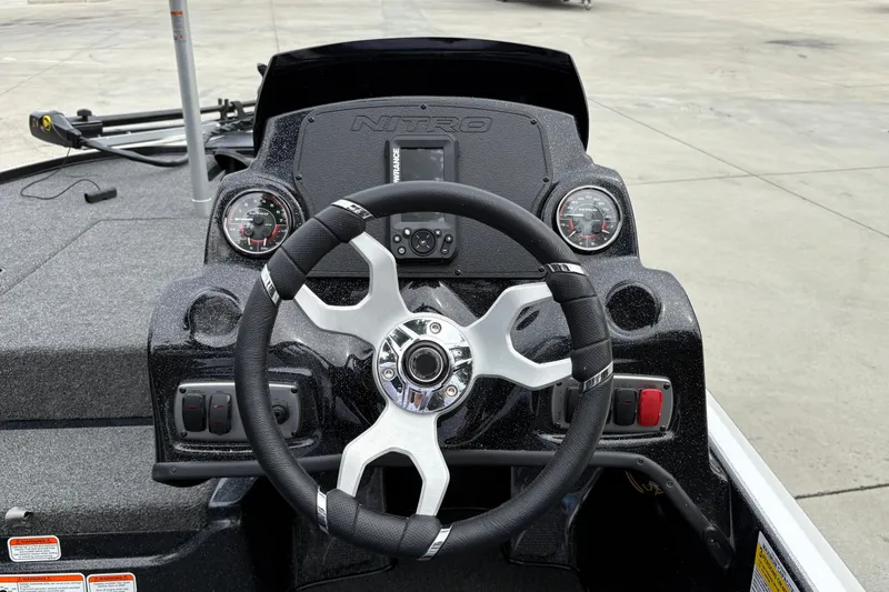 Slide: The Image of Steering console of a 2027 Nitro Z17 boat with gauges and controls. - 17