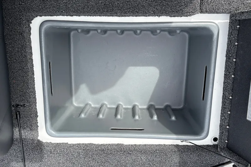Slide: The Image of Empty storage compartment in a 2027 Nitro Z17 boat, featuring a gray interior. - 27