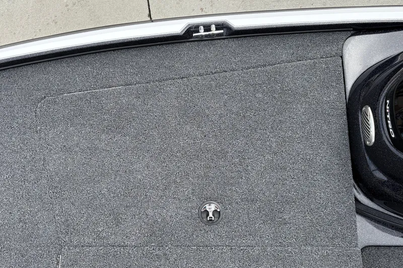 Slide: The Image of Carpeted deck of a 2027 Nitro Z17 boat with a latch and console. - 37