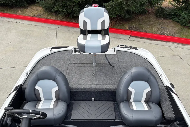 Slide: The Image of 2027 Nitro Z17 boat interior with three gray and white seats on a carpeted deck. - 15