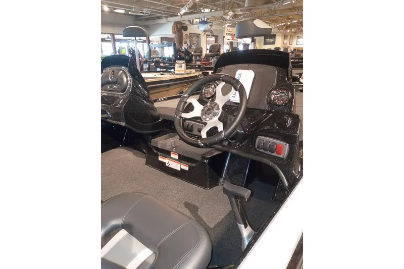 Slide: The Image of Interior view of a 2027 Nitro Z17 boat showcasing steering wheel and dashboard controls. - 9