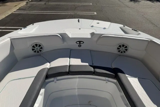 Slide: The Image of 2026 Tahoe 2150 CC boat interior with cushioned seating and speakers. - 10